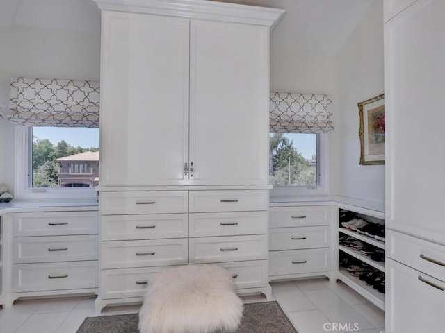 spacious closet with light tile patterned floors