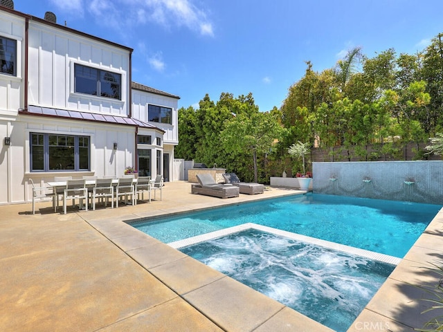 view of swimming pool with an in ground hot tub and a patio area