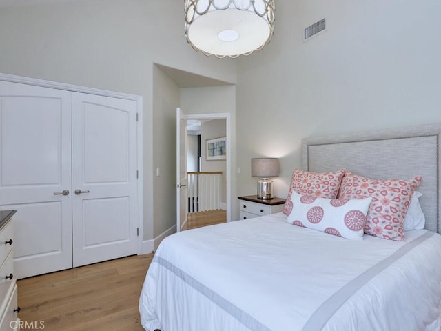 bedroom featuring light hardwood / wood-style floors and a closet