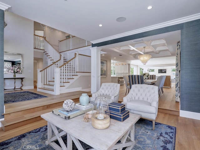 living room with coffered ceiling, hardwood / wood-style flooring, ornamental molding, beamed ceiling, and a chandelier