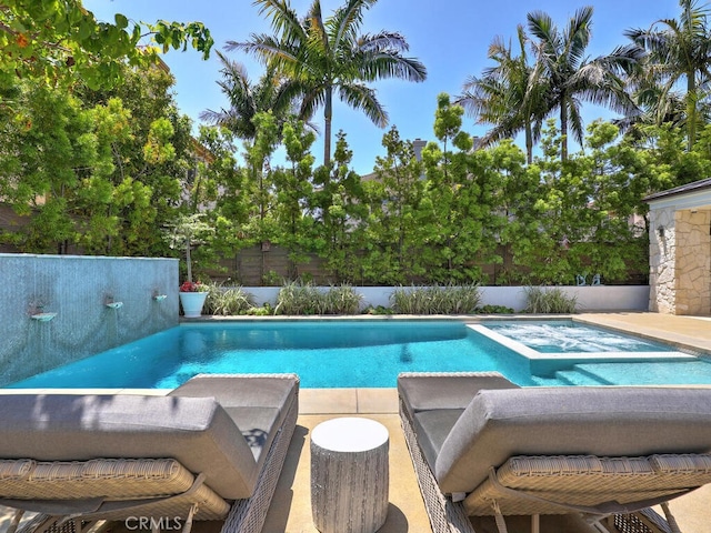 view of swimming pool with an in ground hot tub