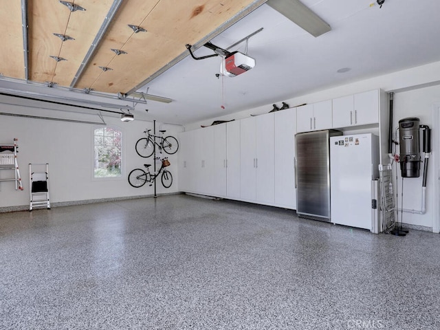 garage with white refrigerator and a garage door opener