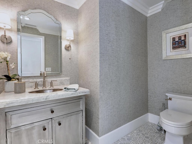 bathroom with tile patterned flooring, toilet, vanity, and ornamental molding