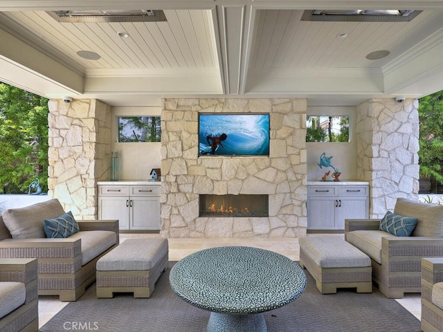 living room with an outdoor stone fireplace