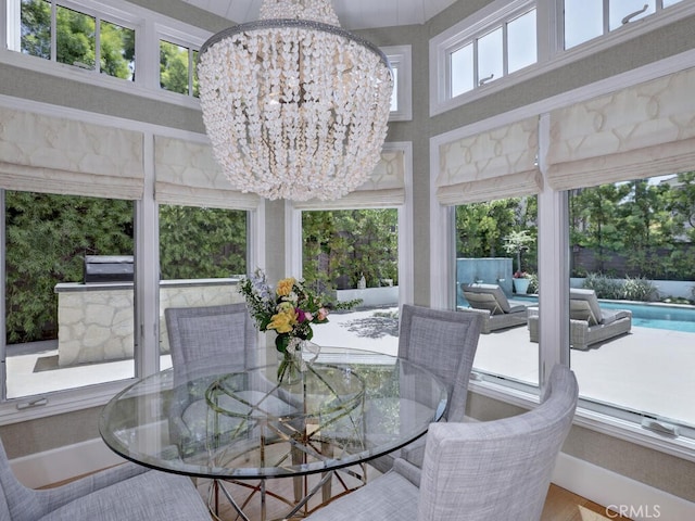 sunroom with a wealth of natural light and an inviting chandelier