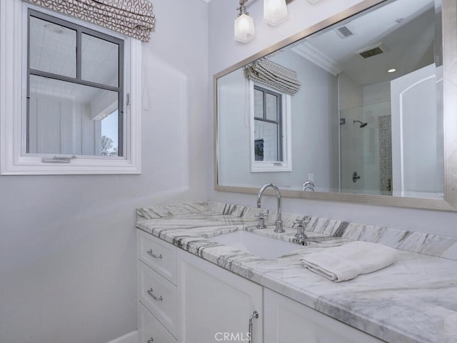 bathroom featuring vanity, an enclosed shower, and crown molding