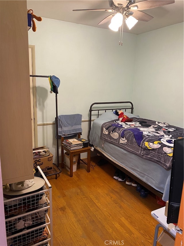 bedroom featuring hardwood / wood-style flooring and ceiling fan