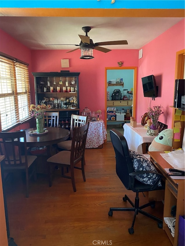 dining area with ceiling fan and hardwood / wood-style flooring