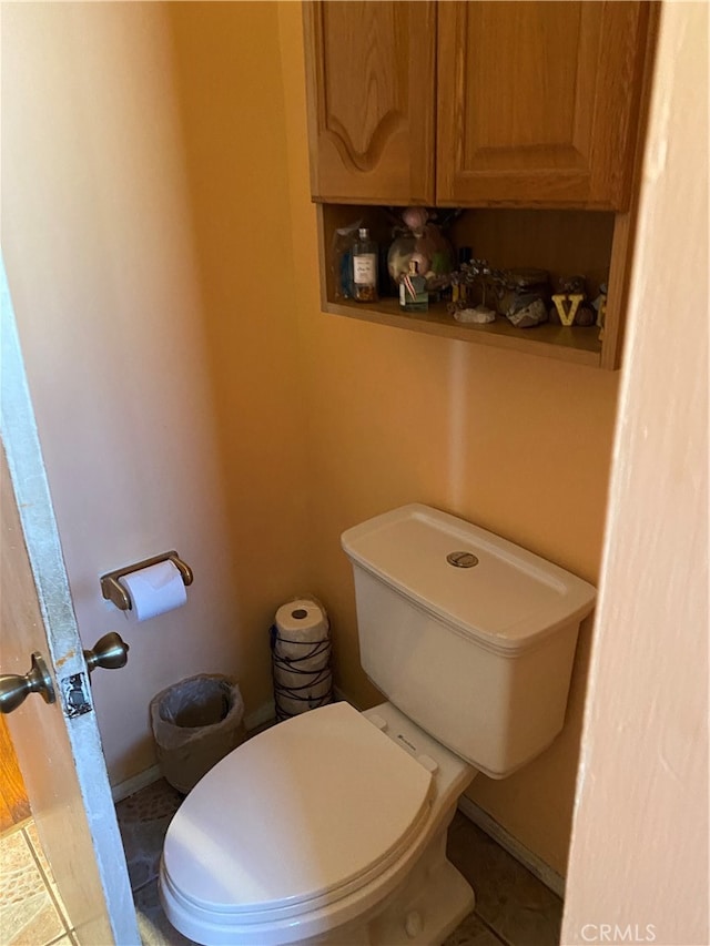 bathroom with tile patterned flooring and toilet