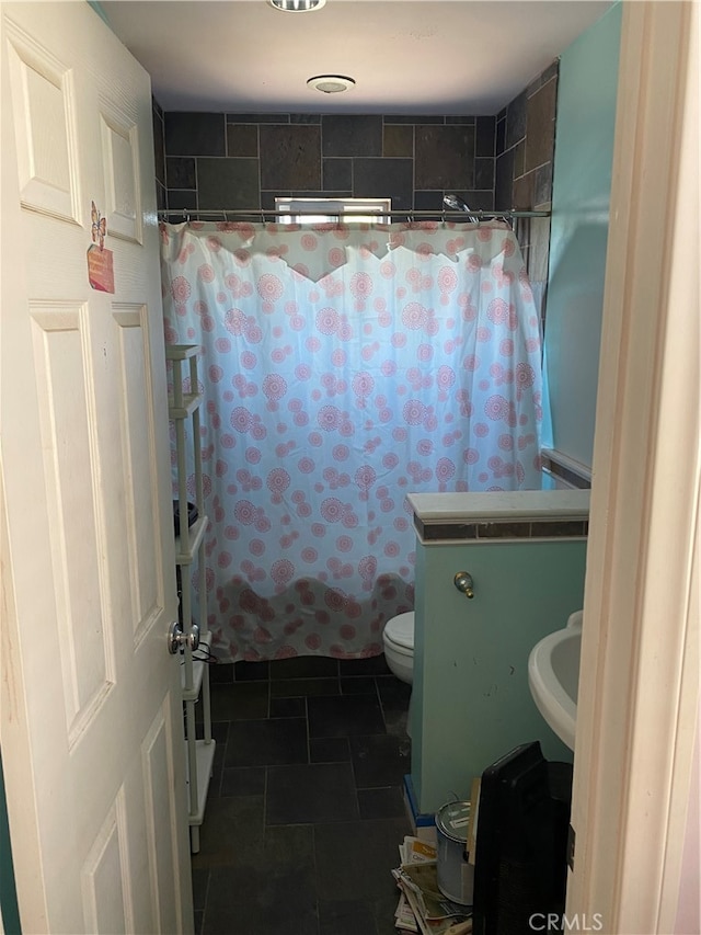 bathroom with sink, toilet, and tile patterned floors