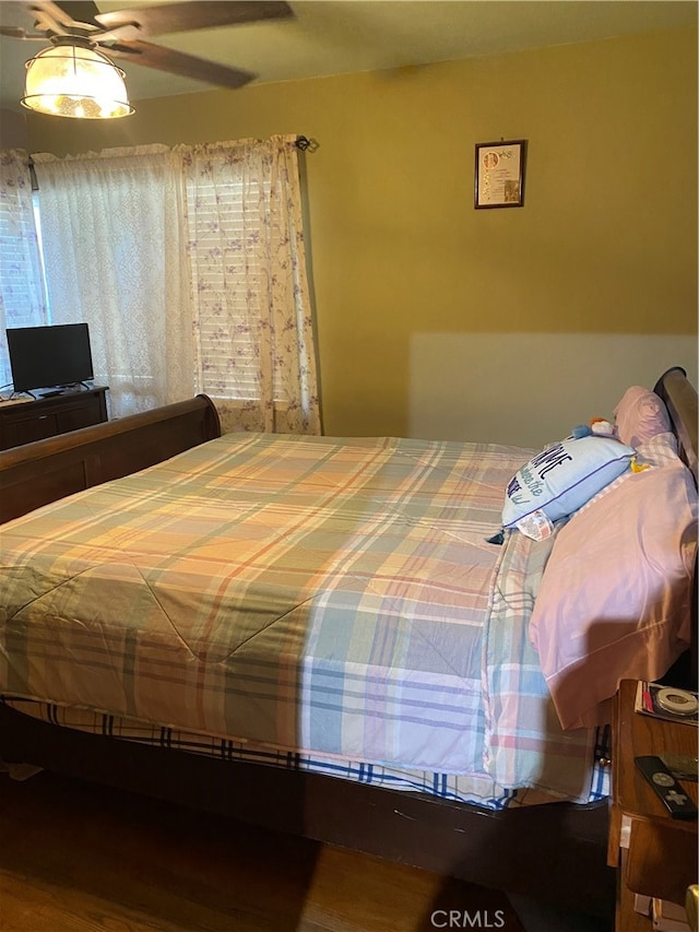 bedroom featuring hardwood / wood-style flooring and ceiling fan