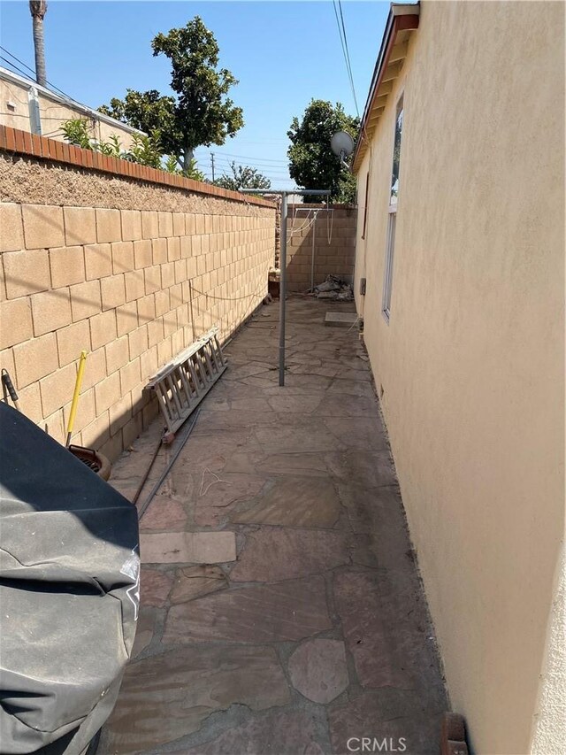 view of side of home featuring a patio