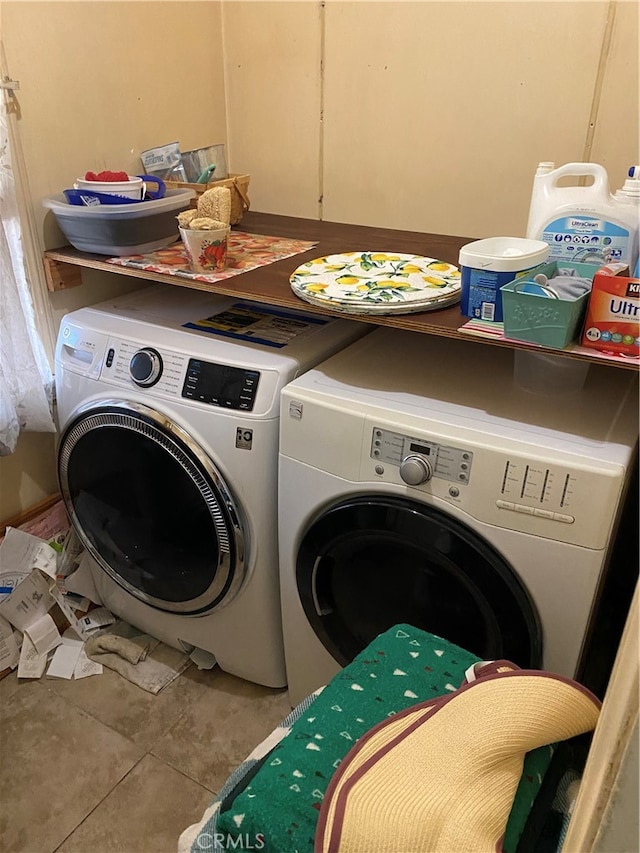 clothes washing area with tile patterned flooring and washing machine and clothes dryer