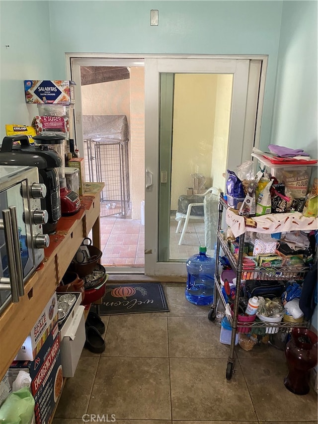 miscellaneous room with tile patterned floors