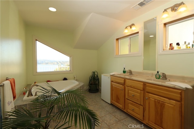 bathroom featuring tile patterned flooring, dual vanity, and a bath