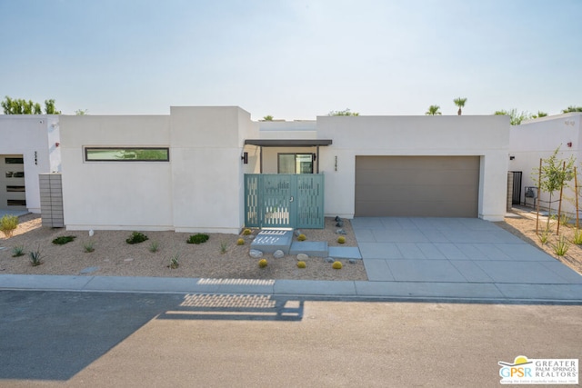 pueblo revival-style home with a garage