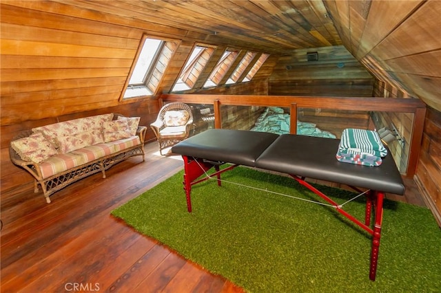 sitting room with wooden ceiling, wooden walls, hardwood / wood-style flooring, and lofted ceiling