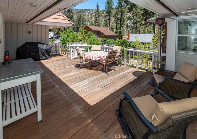 wooden deck featuring a grill