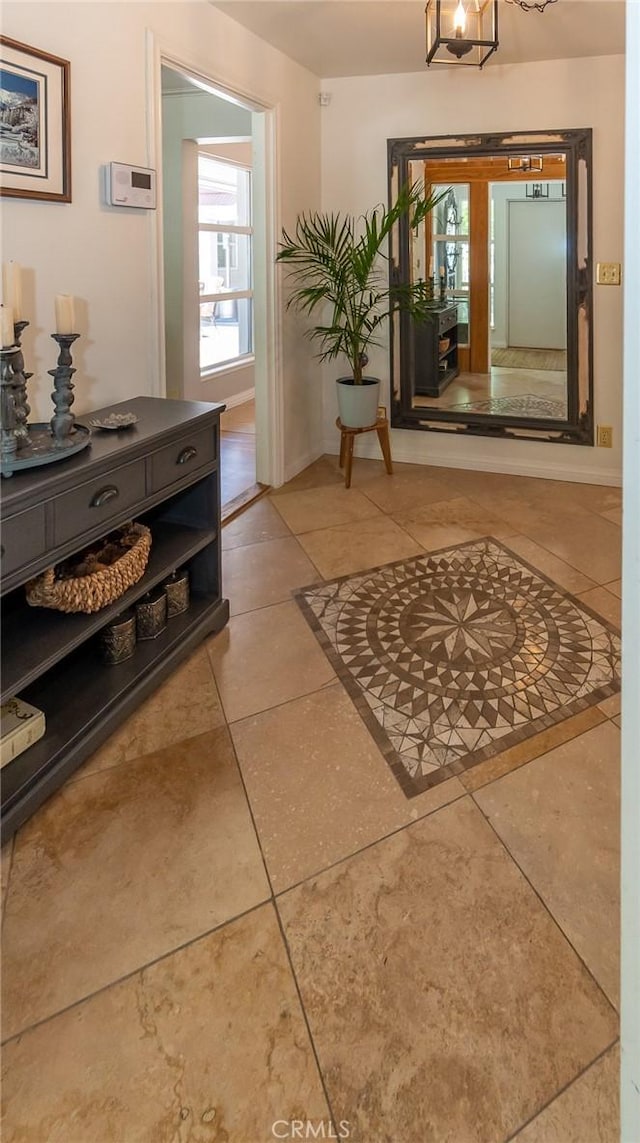 hall with tile patterned floors