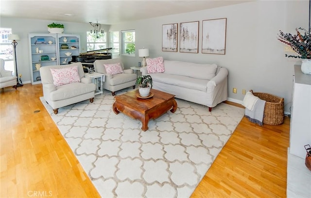 living room featuring wood-type flooring and a chandelier