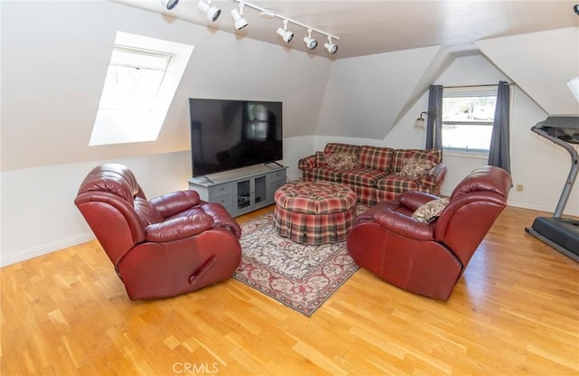 living room with vaulted ceiling and hardwood / wood-style flooring