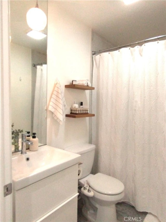 bathroom featuring vanity and toilet