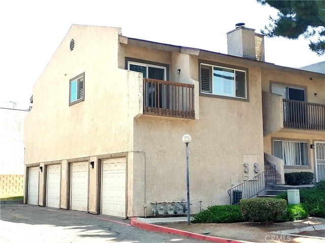 view of building exterior with cooling unit and a garage