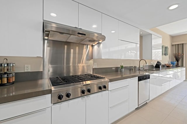 kitchen with sink, white cabinets, stainless steel appliances, and light tile patterned floors