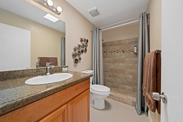 bathroom featuring tile patterned floors, vanity, a shower with shower curtain, and toilet