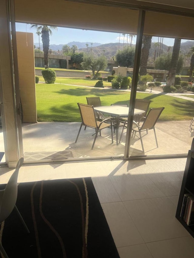 sunroom / solarium with a mountain view and a healthy amount of sunlight