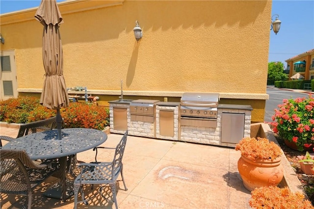 view of patio with exterior kitchen and area for grilling