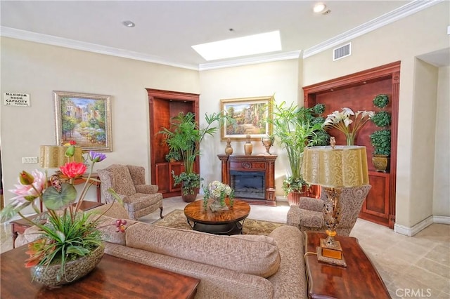 sitting room featuring a skylight and crown molding