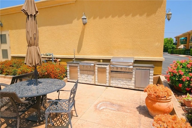 view of patio featuring grilling area and exterior kitchen