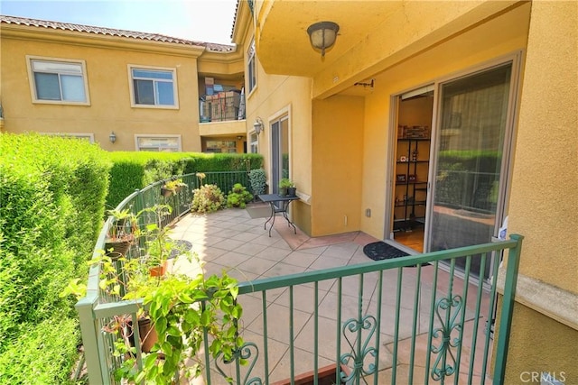 view of patio featuring a balcony