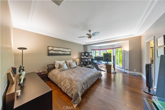 bedroom with ceiling fan and dark wood-type flooring