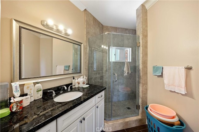 bathroom with vanity, tile patterned floors, and a shower with door