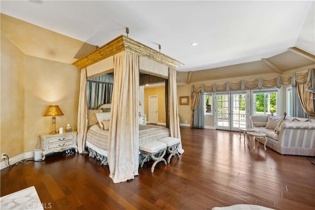 unfurnished bedroom with dark wood-type flooring, access to outside, and vaulted ceiling