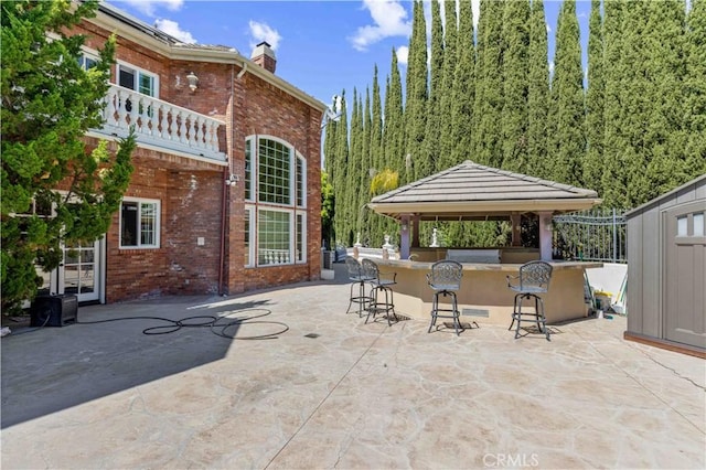 view of patio / terrace featuring a gazebo and a bar