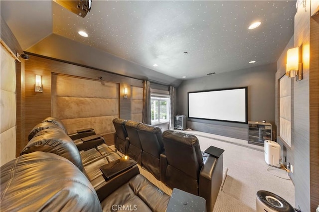 cinema featuring wood walls, carpet floors, and vaulted ceiling