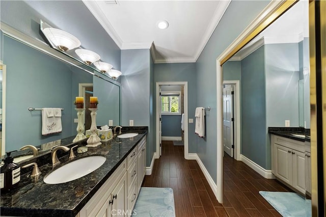 bathroom featuring vanity, hardwood / wood-style flooring, and crown molding