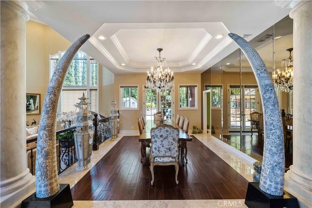 dining area with a healthy amount of sunlight, dark hardwood / wood-style flooring, and ornate columns