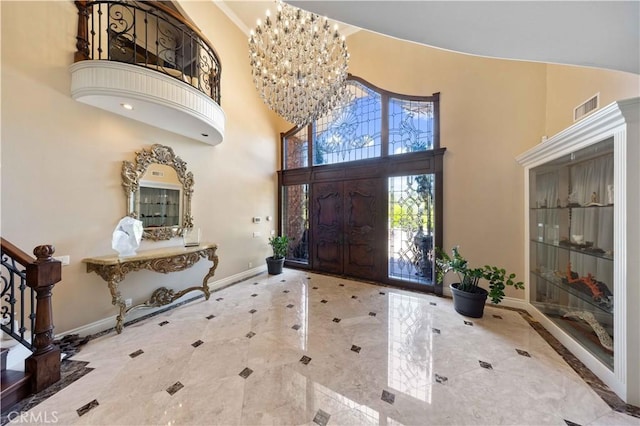 foyer with a towering ceiling and an inviting chandelier