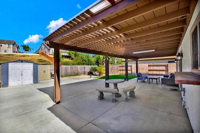 view of patio featuring a fire pit, a pergola, and a storage unit