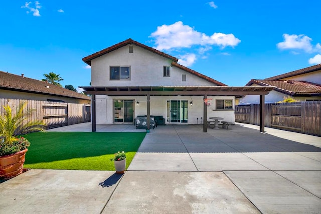 back of house featuring a yard and a patio area