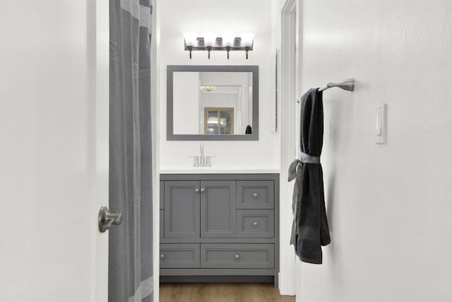 bathroom featuring hardwood / wood-style flooring and vanity