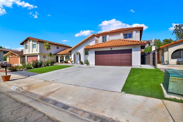 mediterranean / spanish-style house with a garage and a front yard