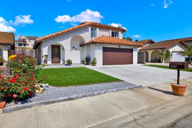 mediterranean / spanish home featuring a garage and a front lawn