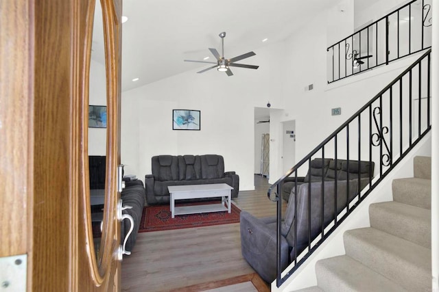 interior space featuring ceiling fan, wood-type flooring, and high vaulted ceiling