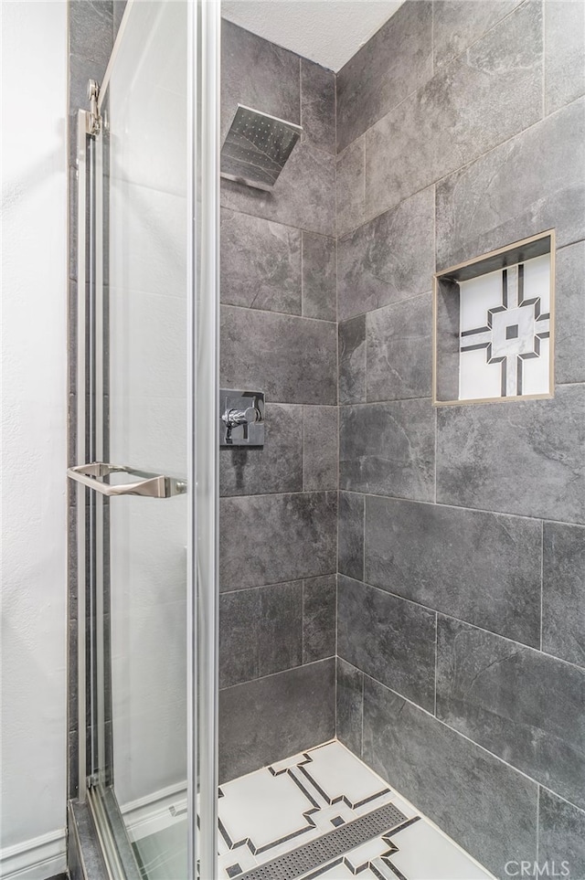 bathroom with a tile shower