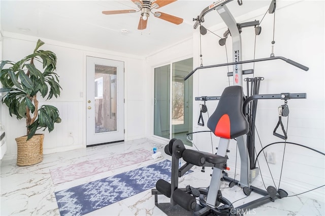 exercise area featuring light tile patterned floors and ceiling fan